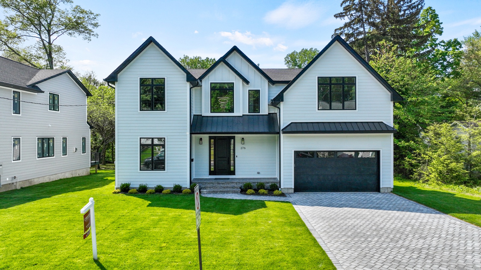 Custom single-family home by Rock Capital Partners with paver driveway in Bergen County, NJ