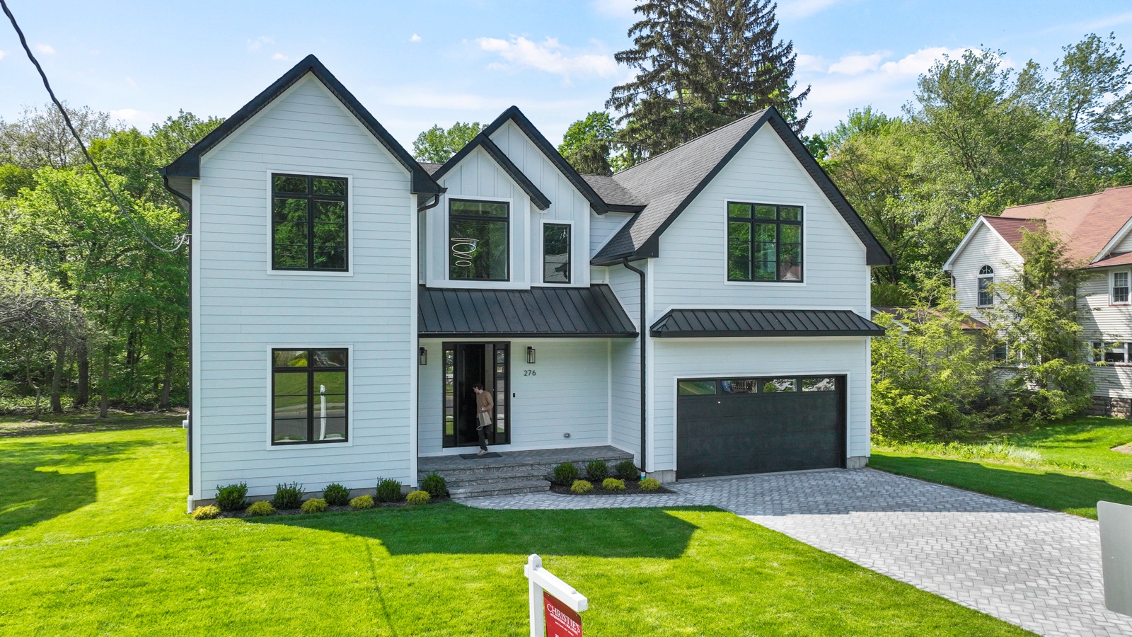 White craftsman home with steep gables built by Rock Capital Partners