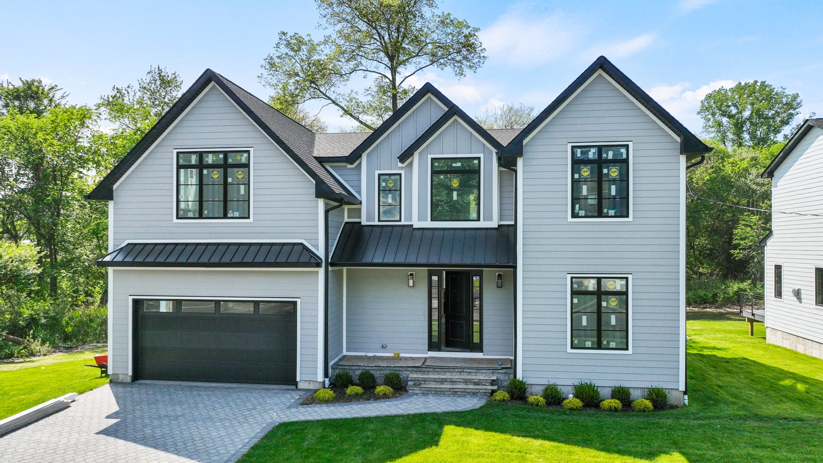 Light-grey craftsman home with double garage by Rock Capital Partners