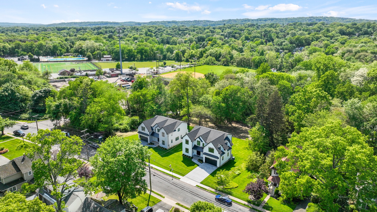 Aerial view of completed Rock Capital Partners homes in a wooded Northern NJ neighborhood