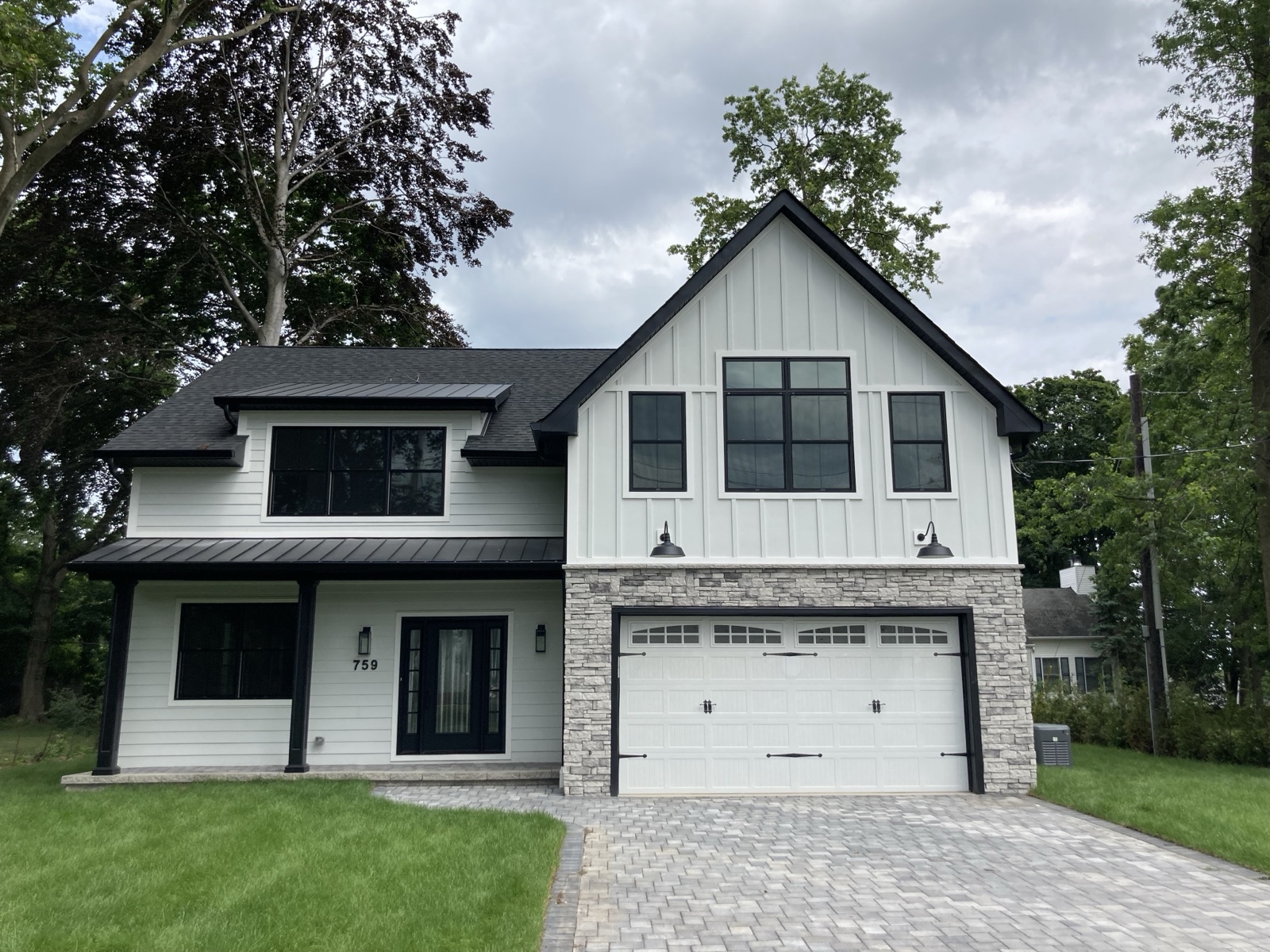 White craftsman home with mixed siding by Rock Capital Partners