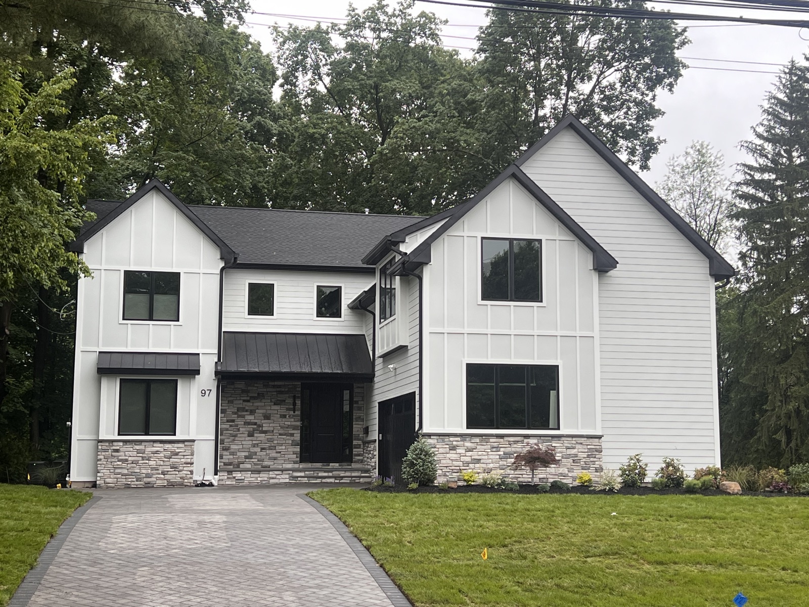 White craftsman home with stone accents by Rock Capital Partners